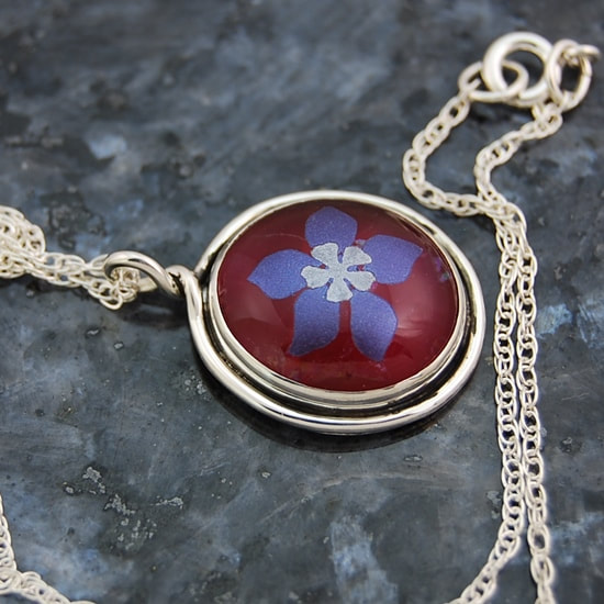 handmade sterling sliver bezel setting with round wire trim top loop with lavender columbine 